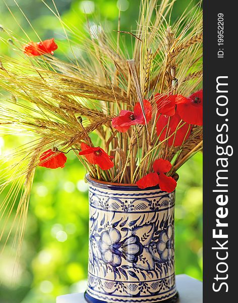 Bouquet of spikes and red poppies.