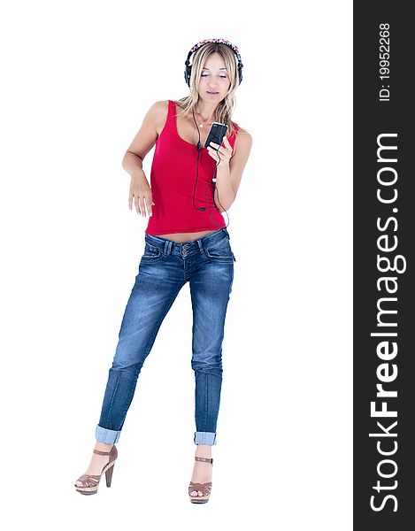 Trendy woman listening to music on her mp3 player wearing headphones. Trendy woman listening to music on her mp3 player wearing headphones