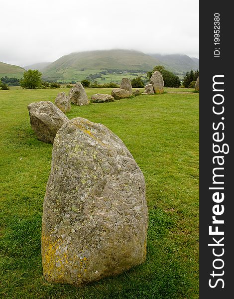 Part of Castlerigg stone circle near Keswick in Cumbria England showing low cloud on nearby hills