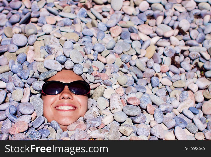 Funny girl in sunglasses in stones. Funny girl in sunglasses in stones