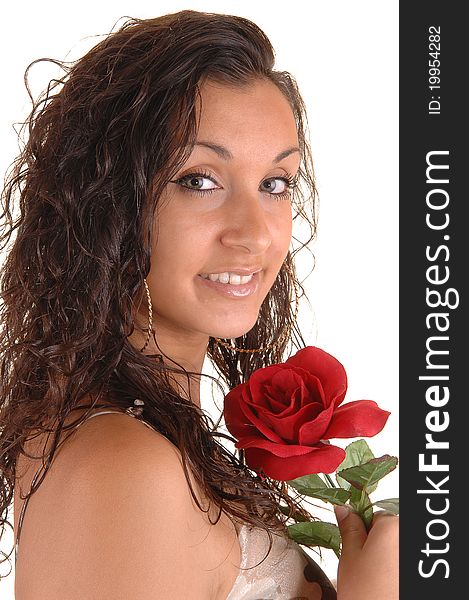 Lovely young teenager in a portrait shot with a red rose and curly hair, for white background. Lovely young teenager in a portrait shot with a red rose and curly hair, for white background.