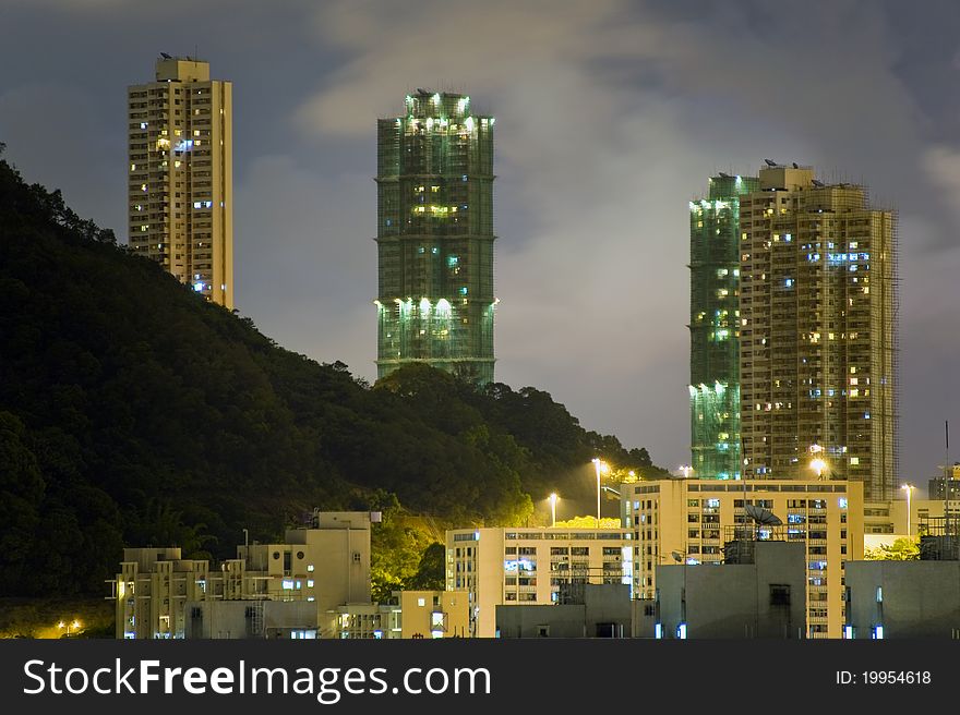 Hong Kong Night Sky with Sparkling Tungsten Lighting Coming Out from Buildings adjacent to Hillside. Hong Kong Night Sky with Sparkling Tungsten Lighting Coming Out from Buildings adjacent to Hillside