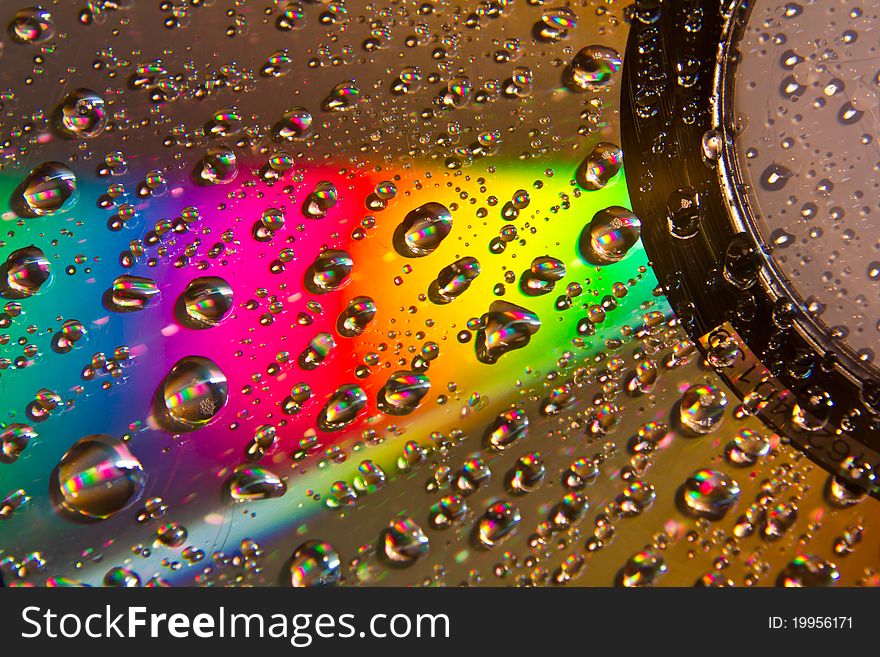 Images drops of water on the CD reflect rainbow colors. Images drops of water on the CD reflect rainbow colors.