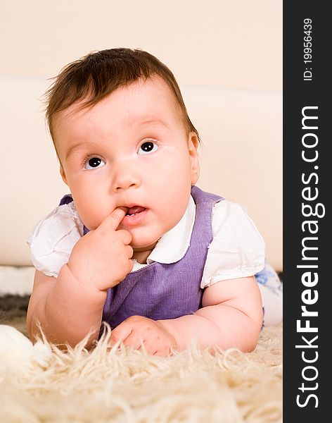 Portrait of a baby lying on a carpet. Portrait of a baby lying on a carpet