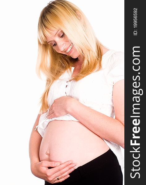 Pregnant woman in white standing on a white background
