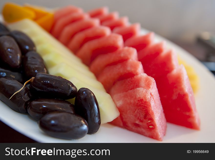 Nicely cut and arranged fruits on a platter tray ready to be served. Nicely cut and arranged fruits on a platter tray ready to be served.