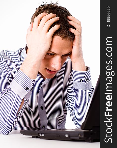 Young worker sitting at table with laptop. Young worker sitting at table with laptop