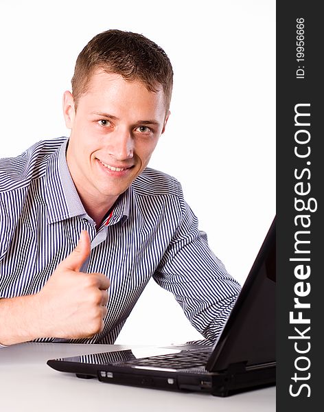 Young worker sitting at table with laptop. Young worker sitting at table with laptop