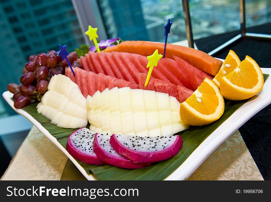 A plate of nicely sliced and decorated fruits ready to be served. A plate of nicely sliced and decorated fruits ready to be served.