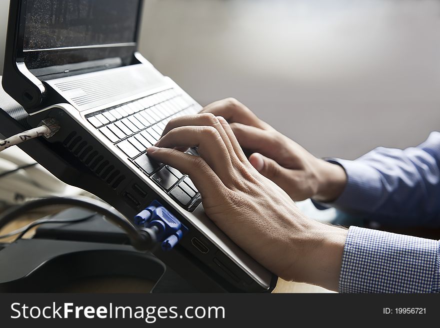 Hands on the laptop s keyboard