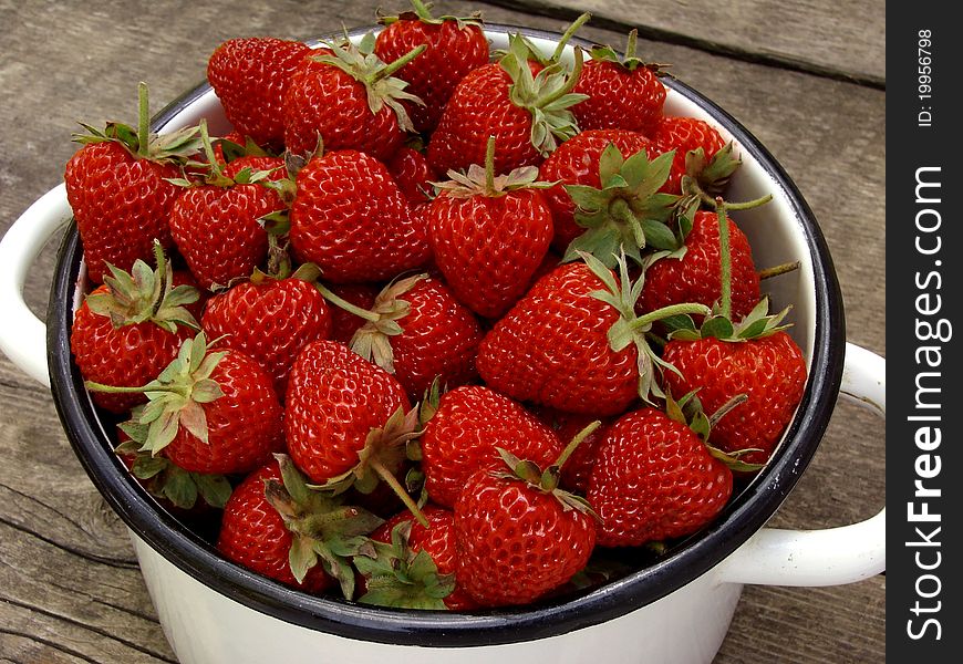 Saucepan full of fresh cropped strawberries. Saucepan full of fresh cropped strawberries
