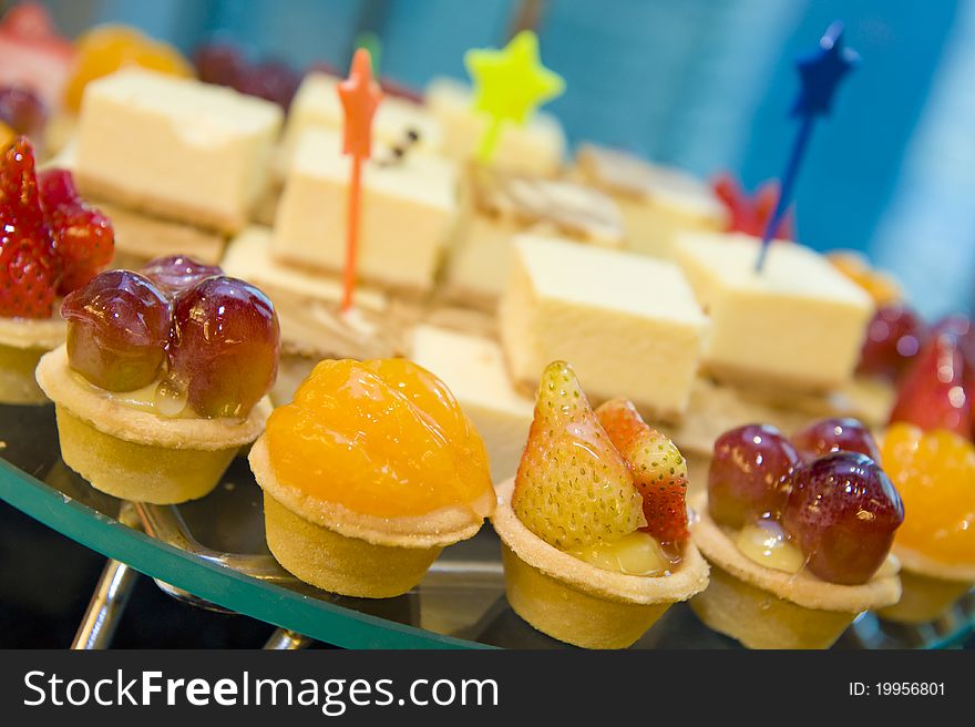 A plate of delicious canapes and sweets on the serving table at a launch reception.