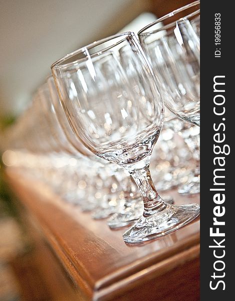Cocktail drink glasses lined up on a table ready to be filled and served. Cocktail drink glasses lined up on a table ready to be filled and served.