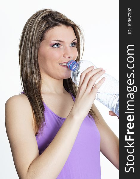 Beautiful blond woman drinking water after sport