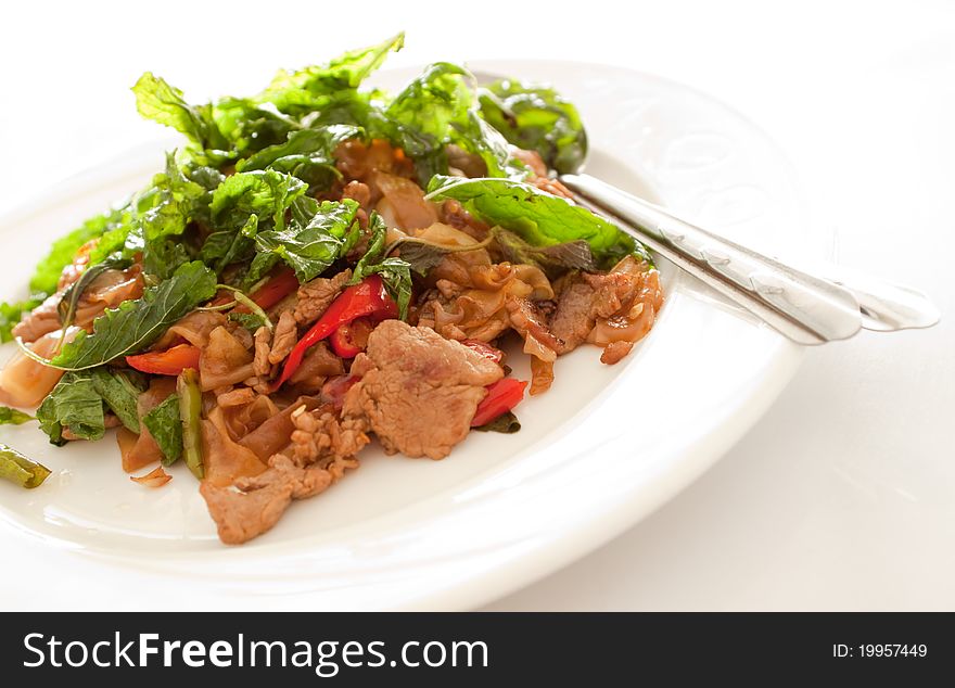 Thai style fried noodle topping with holy basil