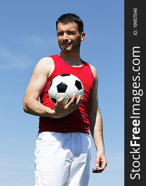 Man with ball and blue sky in summer