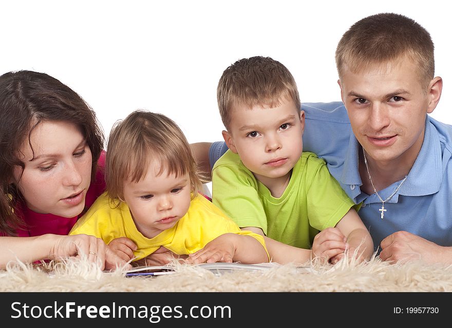 Cute family of a four  lying on carpet. Cute family of a four  lying on carpet