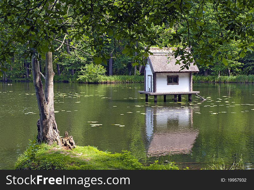 Duck house on a lake in a park. Duck house on a lake in a park