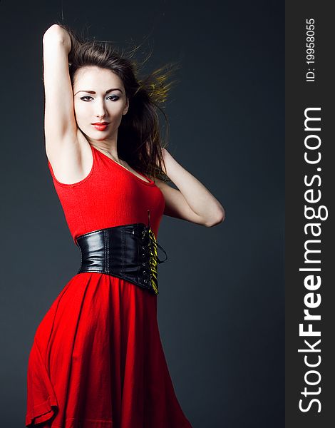 Young woman in a red dress, beautiful young girl dances. Young woman in a red dress, beautiful young girl dances