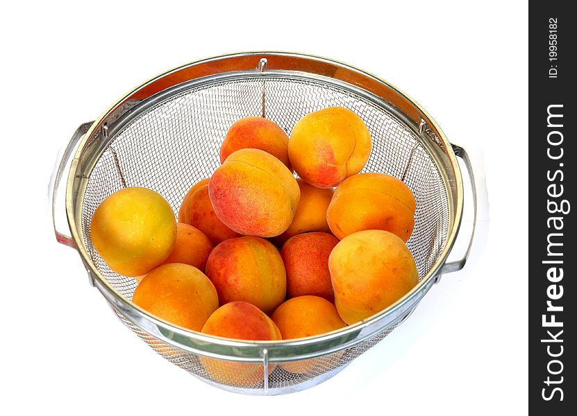 Apricots in a strainer ready to be rinsed with water. Apricots in a strainer ready to be rinsed with water