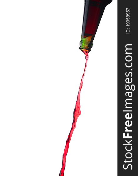 Splashing red water from bottle, isolated over white background.