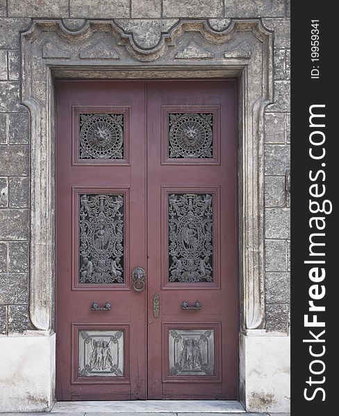 Old wooden door with metal decorations in historical house. Old wooden door with metal decorations in historical house