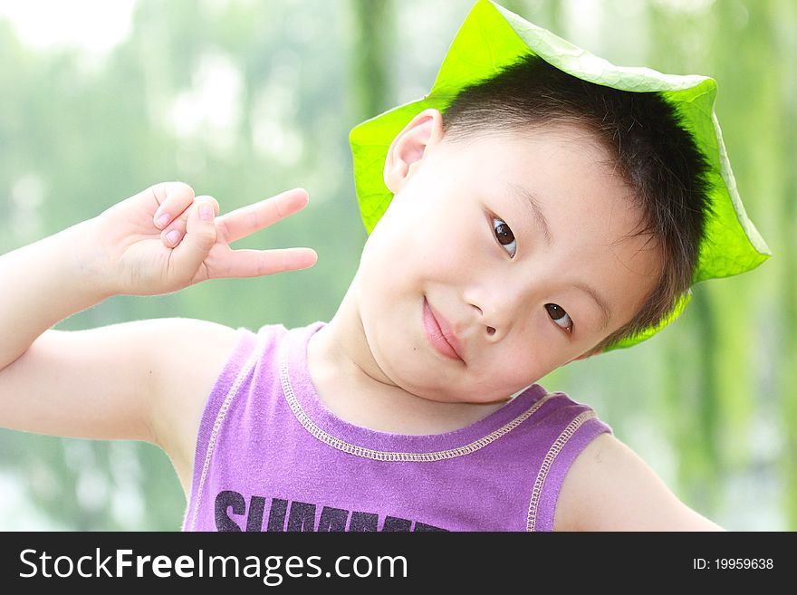 Asian boy with leaf cap