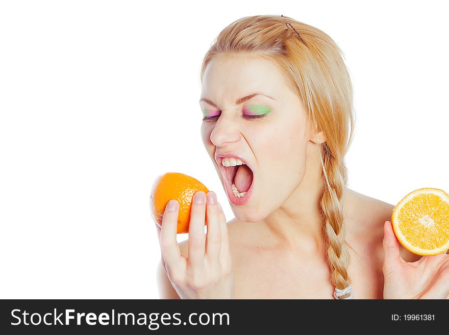 Young woman yells at oranges in her hands. Young woman yells at oranges in her hands