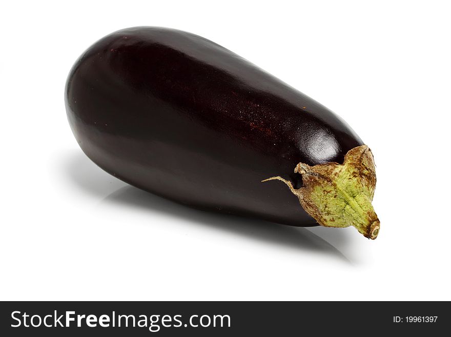 Eggplant, on the polished surface, isolated on a white background in studio. Eggplant, on the polished surface, isolated on a white background in studio.