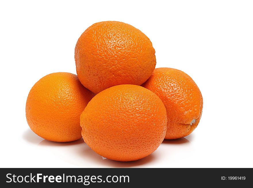 Oranges on a polished surface, isolated on a white background in studio. Oranges on a polished surface, isolated on a white background in studio.