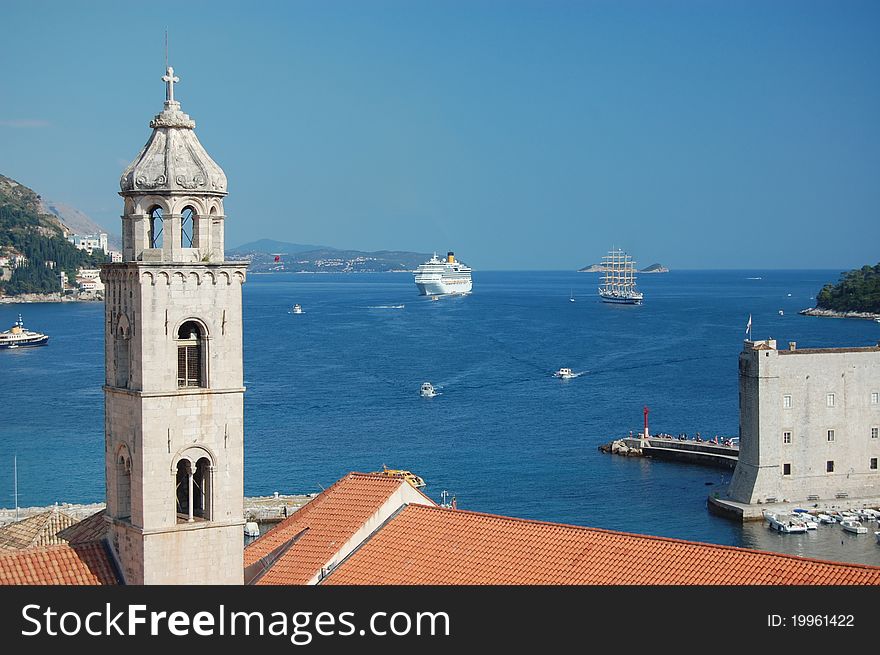 A photograph of a cruise liner and a sailboat outside the ancient city of Dubrovnik in Croatia. A photograph of a cruise liner and a sailboat outside the ancient city of Dubrovnik in Croatia