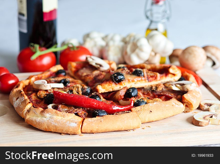 Pizza with salami on a cutting board