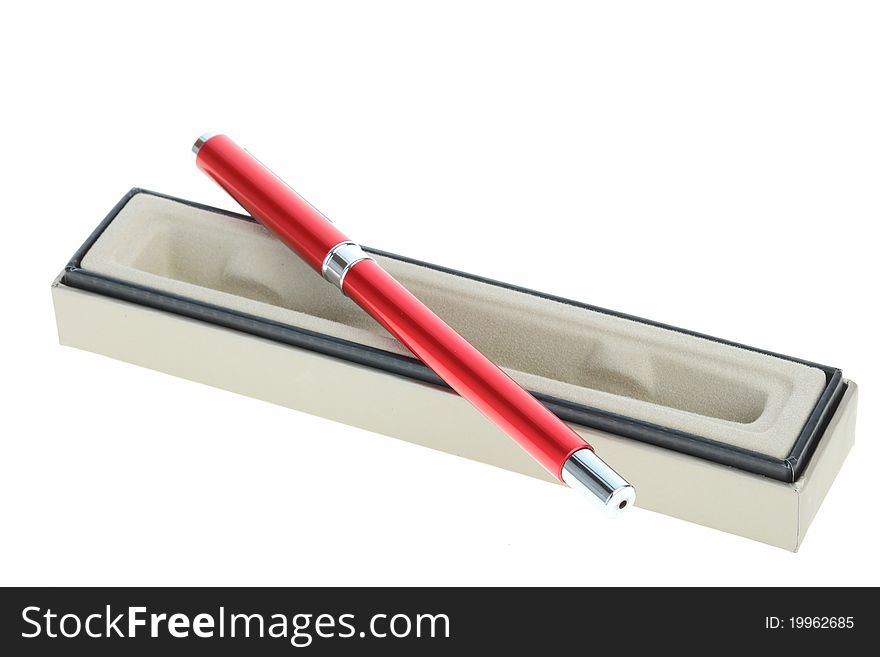 Red pen lays on a box that opens the lid and white background