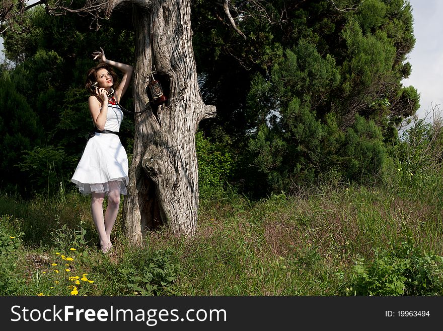 Pinup style beautiful girl speaks on telephone. Pinup style beautiful girl speaks on telephone