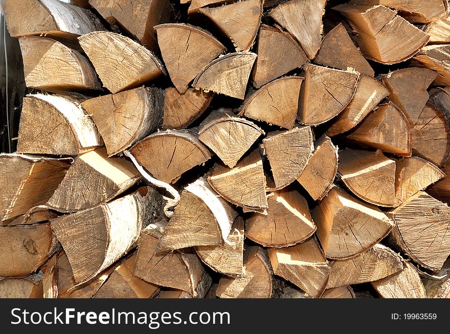 Chipped birch fire wood is combined in piles