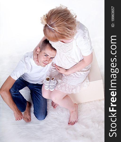 Studio shot of young couple expecting a baby