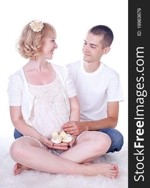 Studio shot of young couple expecting a baby