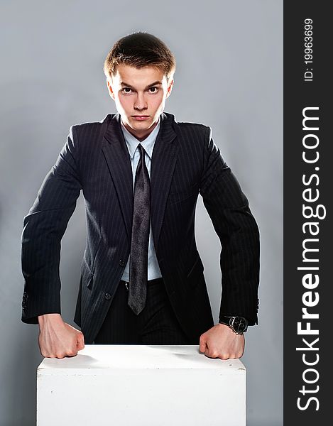 Young and seriously businessman stand