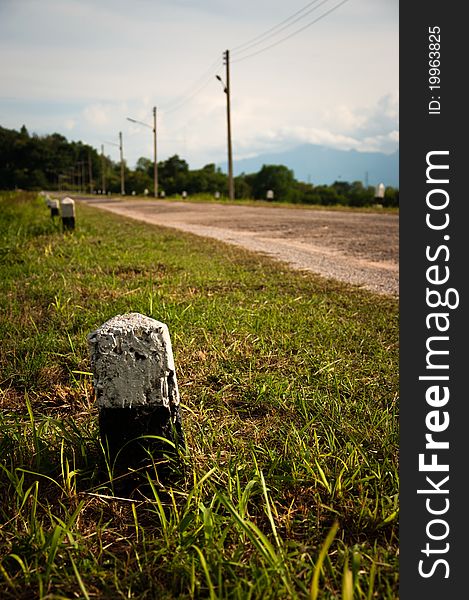 Road with Kilometer stones on two sides along with electricity posts. Road with Kilometer stones on two sides along with electricity posts