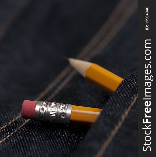 Two yellow pencils in jeans pocket