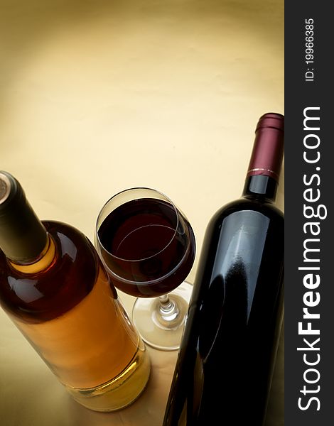 Bottle and glass of wine on a dark background