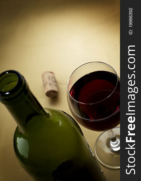 Bottle and glass of wine on a dark background