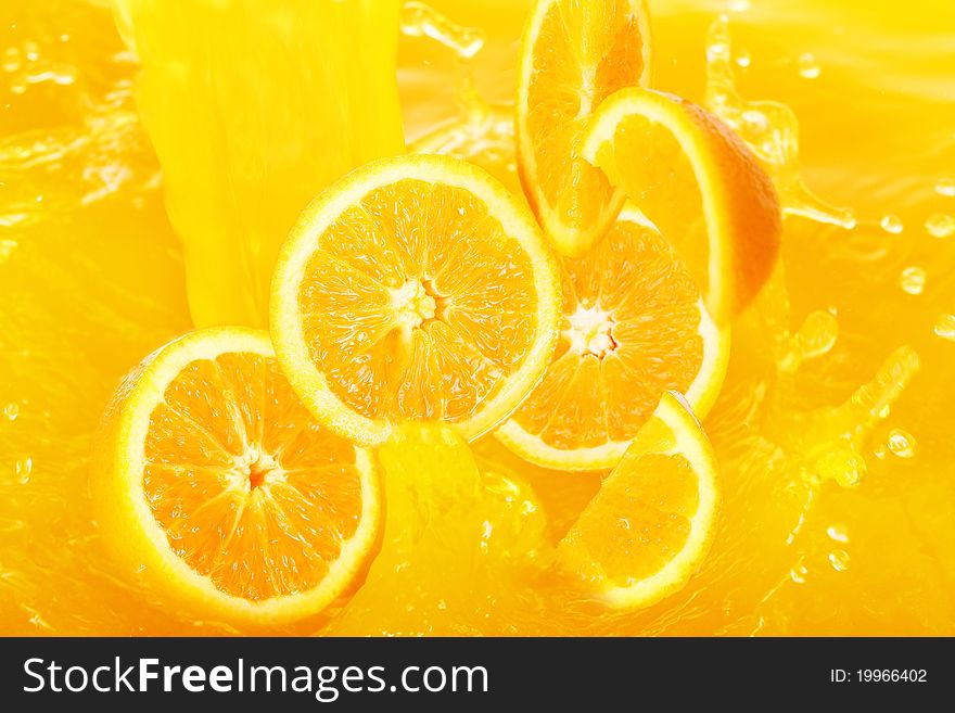 Fresh oranges falling in juice with lot of huge splashes