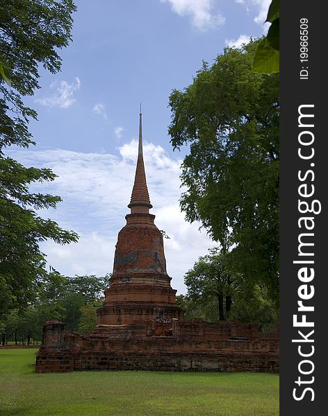 Damaged pagoda is located within the park. Ayutthaya, Thailand. Damaged pagoda is located within the park. Ayutthaya, Thailand