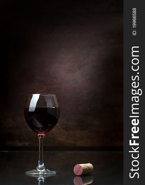 Glass of red wine on a dark background. Glass of red wine on a dark background