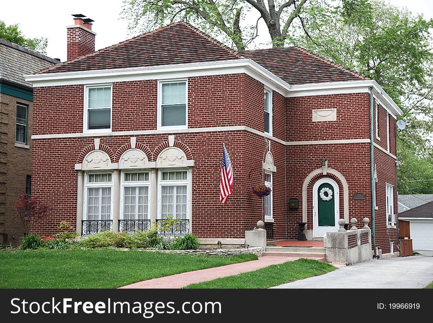 Image of brick house with nice landscaping.