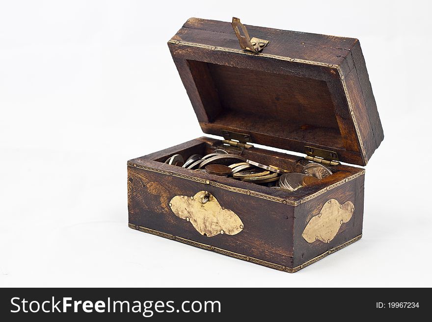 A small wooden chest full of coins. A small wooden chest full of coins