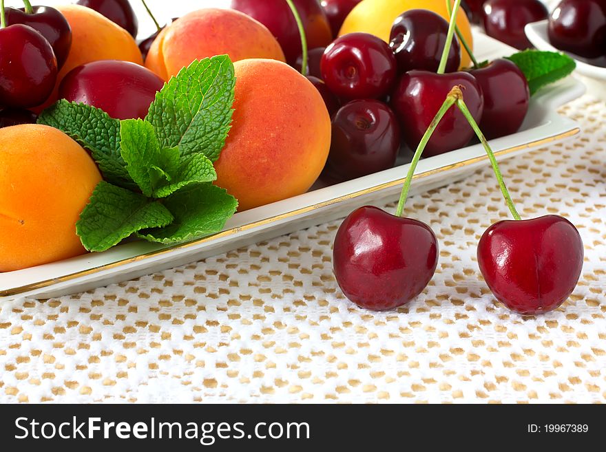 Plate with fruits, cherries, apricots, plums and mint. Plate with fruits, cherries, apricots, plums and mint.