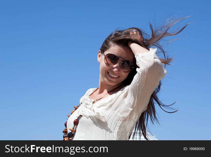 Portrait of a beautiful young woman smiling against the sky - Outdoor. Portrait of a beautiful young woman smiling against the sky - Outdoor