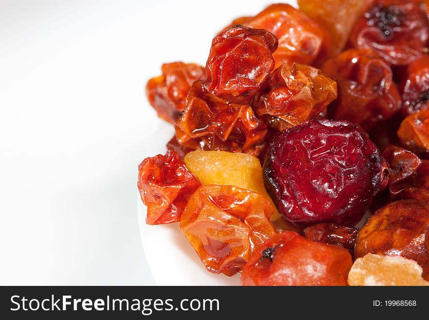 Some kinds of candied fruits on a light surface close up. Some kinds of candied fruits on a light surface close up.